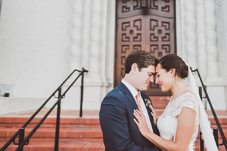 Newlyweds pose by the Chapel entrance