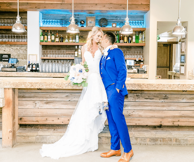 Bride & Groom Pose by the Bar at Galway Downs