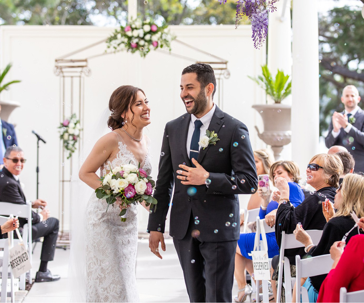 Take advantage of the endless photo opportunities featuring a wisteria-draped veranda, glimmering bay waters, and the meticulously-designed surroundings of the stunning historic mansion - Jefferson St Mansion by Wedgewood Weddings