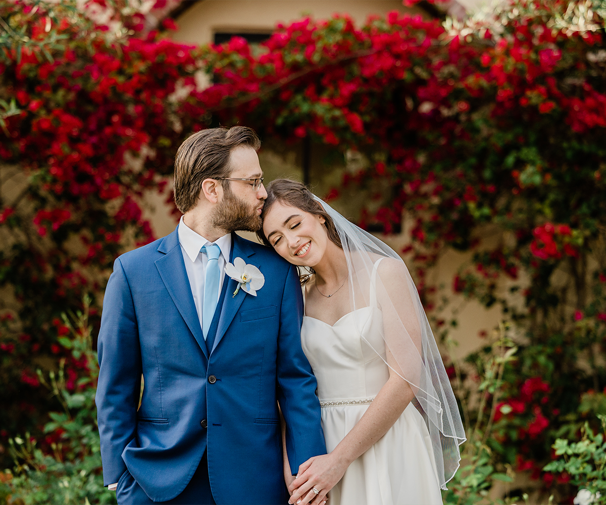 Couple in front of bright flowers - Aliso Viejo by Wedgewood Weddings