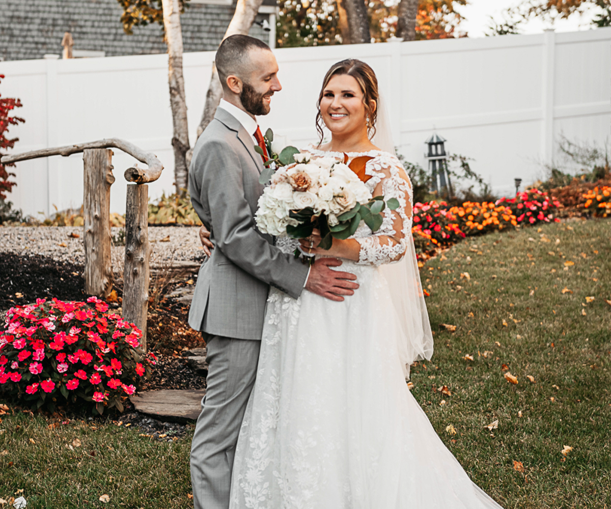 Couple outside by flowers at Barker House by Wedgewood Weddings
