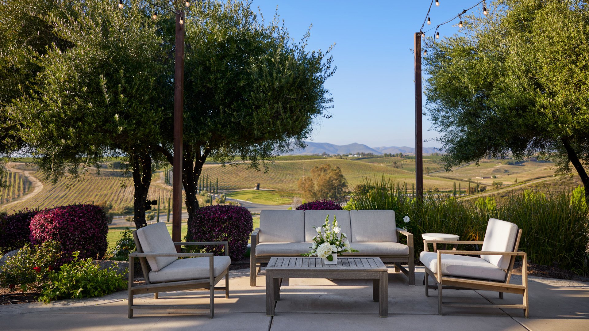 Comfortable lounge seating on the cocktail patio at Bel Vino Winery overlooking scenic vineyard hills.