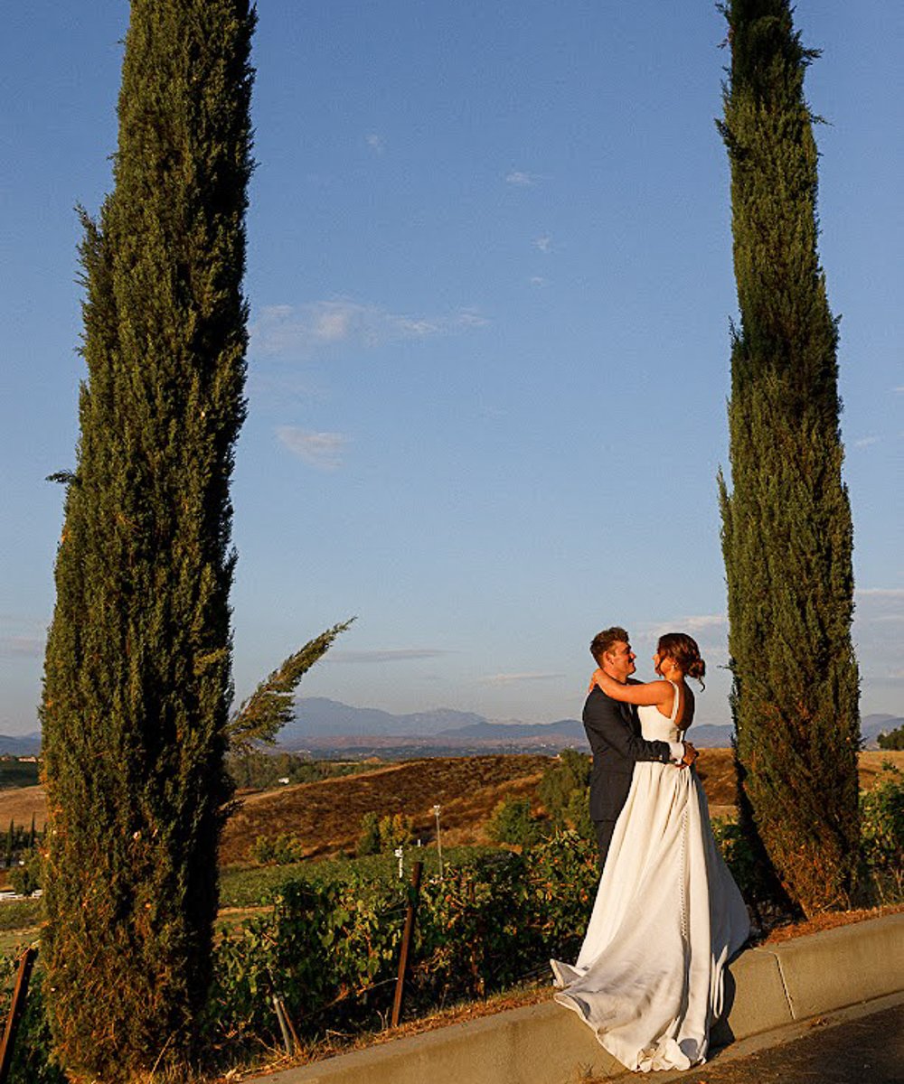 Couple with trees, vineyard views - Bel Vino Winery by Wedgewood Weddings