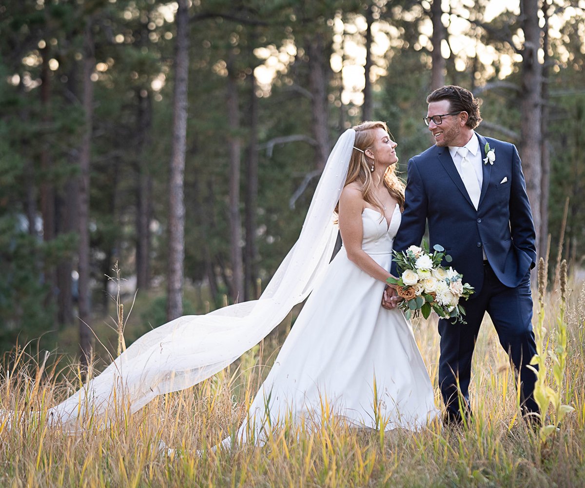 Couple in meadow at Black Forest by Wedgewood Weddings