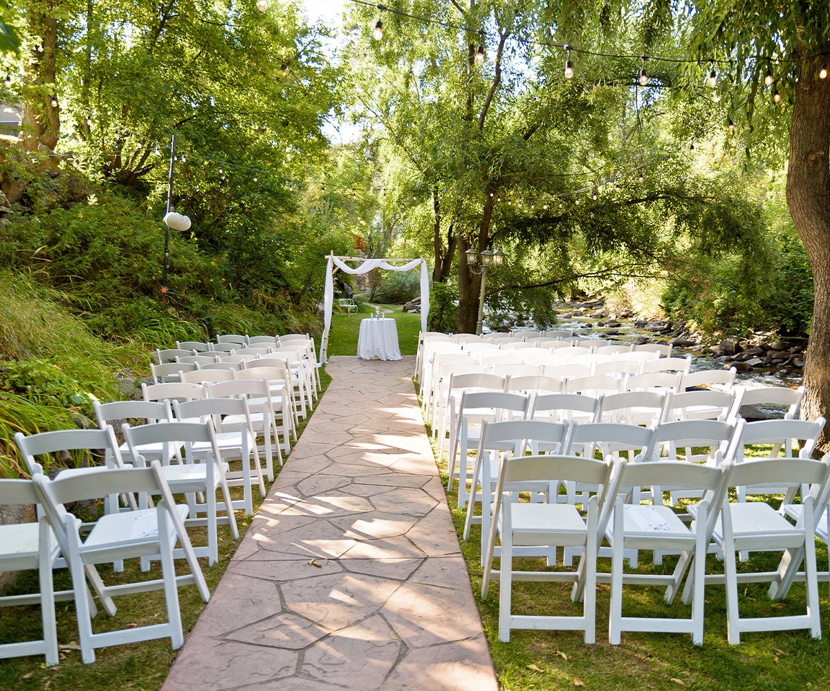 Intimate Wedding Ceremony by the Creek Surrounded by Lush Greenery in Boulder, Colorado