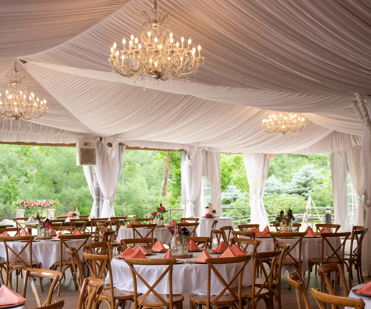 Boulder Creek Wedding Pavilion Interior Highlighting Whimsical Crystal Chandeliers and High Ceilings in Colorado