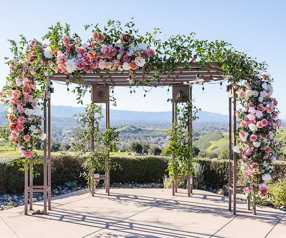 Arch with pink flowers and greenery - Boulder Ridge by Wedgewood Weddings