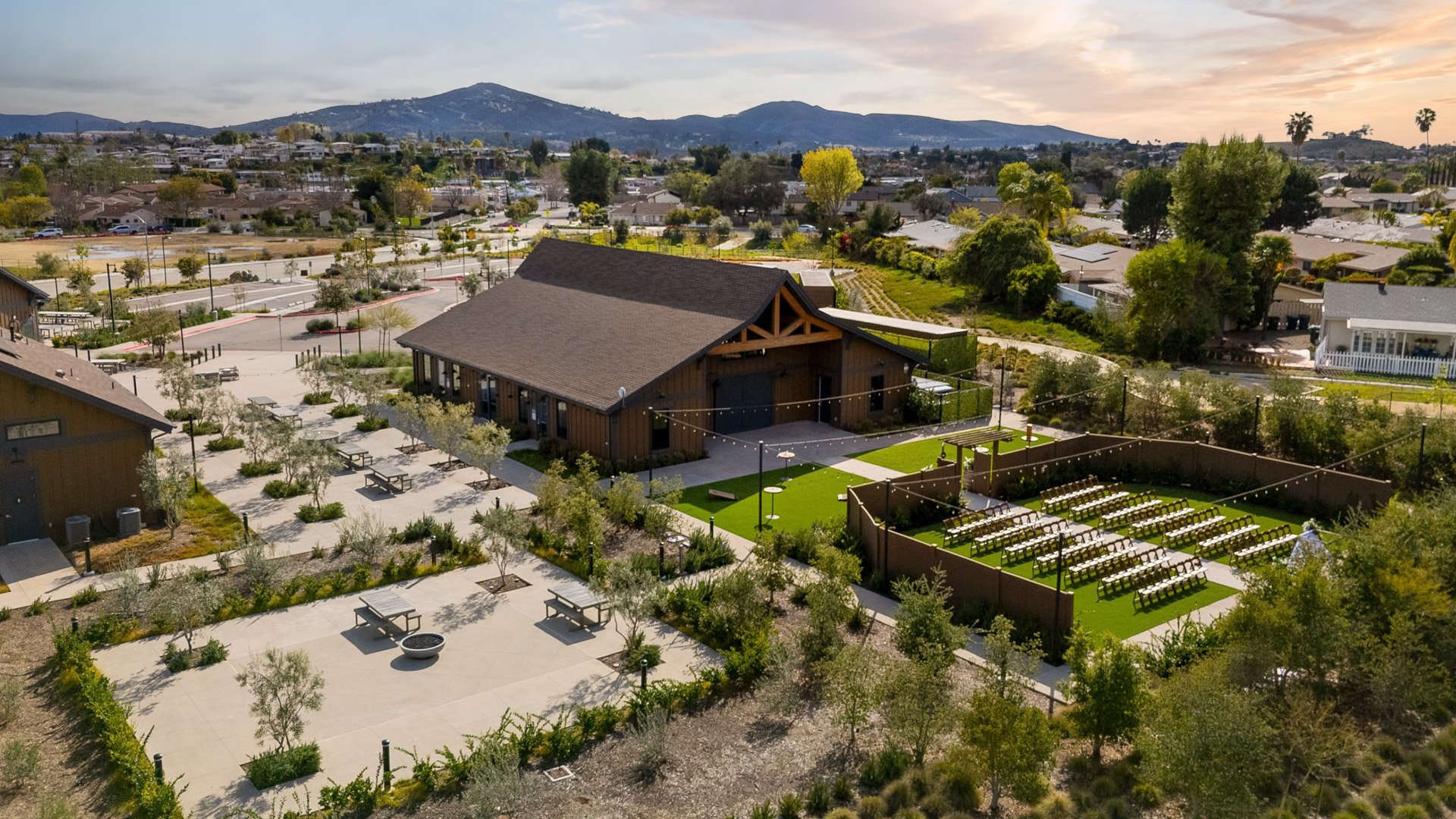 Aerial view of Canopy Grove wedding venue showing rustic barn, ceremony lawn, and surrounding mountains in Escondido, CA.