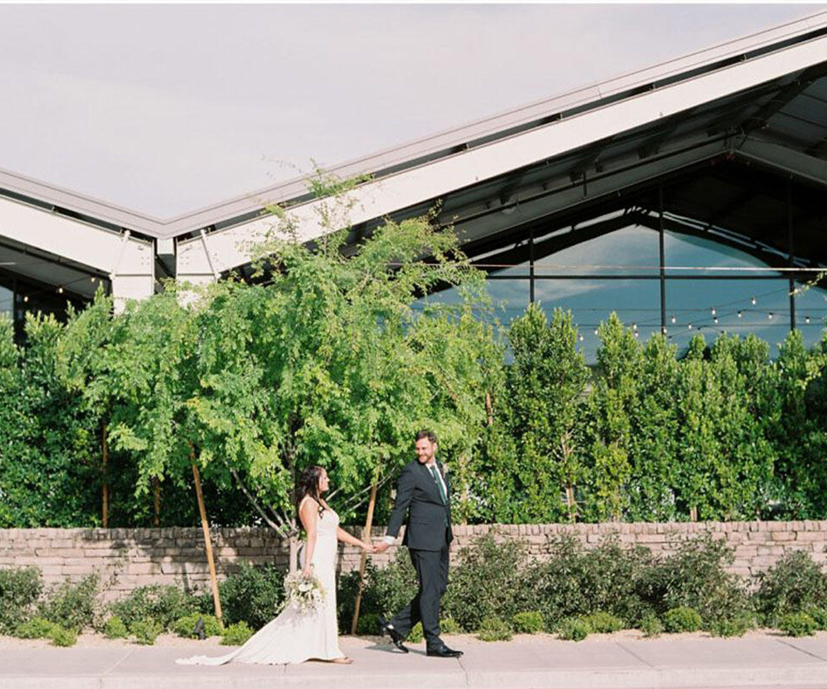 Couple walking down street outside Clayton House by Wedgewood Weddings