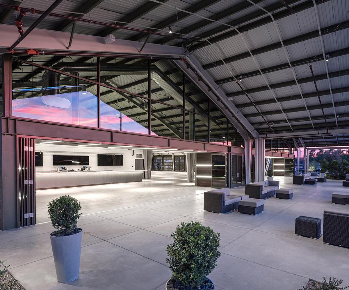 Industrial chic indoor outdoor patio with built in bar atClayton House by Wedgewood Weddings