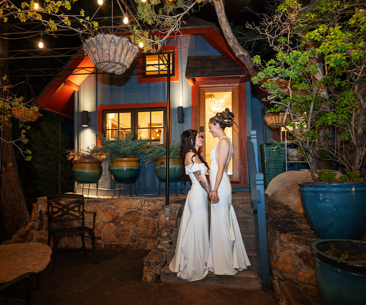 Brides posing outside charming cottage - Craftwood Peak by Wedgewood Weddings