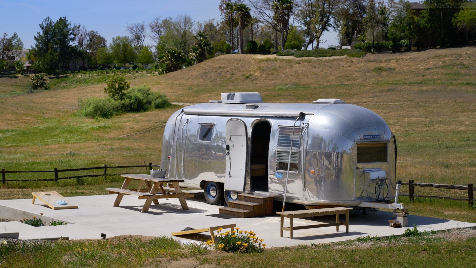 Unique Silver Airstream Suite at Danza del Sol Winery in Temecula, CA, set among rolling hills with outdoor picnic space for wedding parties.