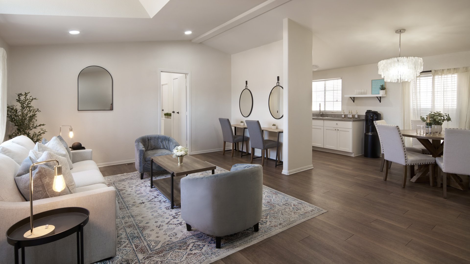 Spacious bridal suite at Danza del Sol Winery in Temecula, CA, featuring modern seating, vanity mirrors, dining area, and natural light for getting ready.
