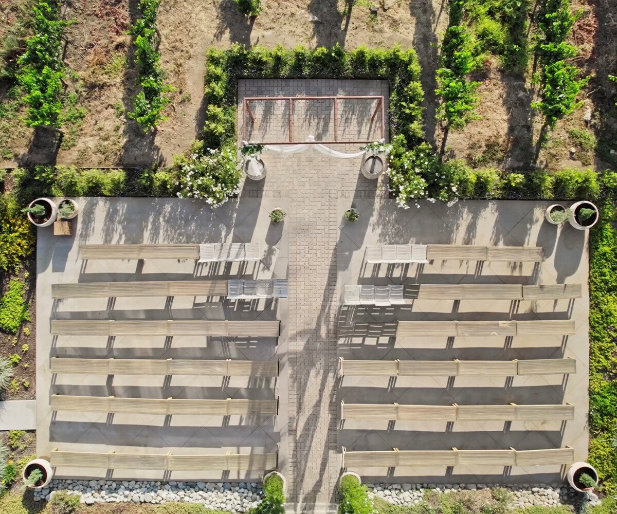 Aerial view of Danza del Sol Winerys wedding venue in Temecula showing ceremony layout, brick aisle, and surrounding vineyards.