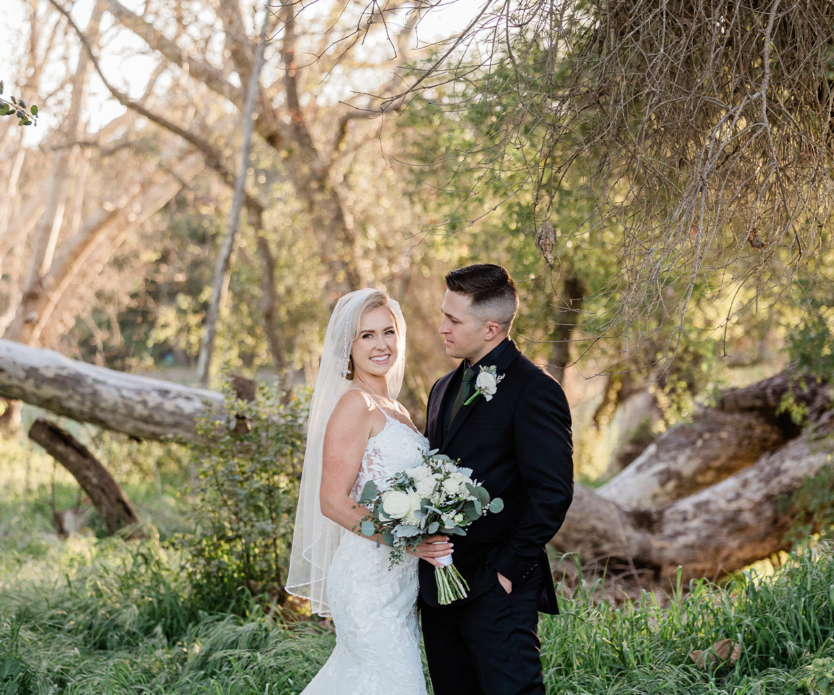 Bride and groom in front of trees & greenery at Fallbrook Estate by Wedgewood Weddings