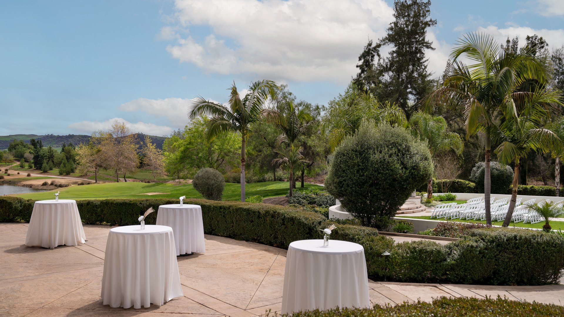 Elegant outdoor wedding reception patio at Fallbrook Estate Wedgewood Weddings with cocktail tables, hedge landscaping and scenic golf course views in Fallbrook California