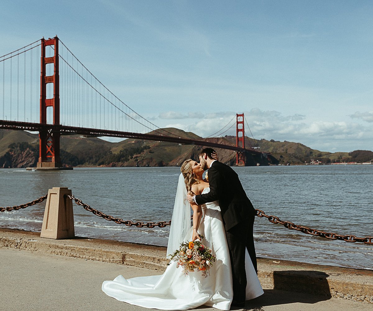 Couple in front of Golden Gate Bridge - Golden Gate Club at the Presidio