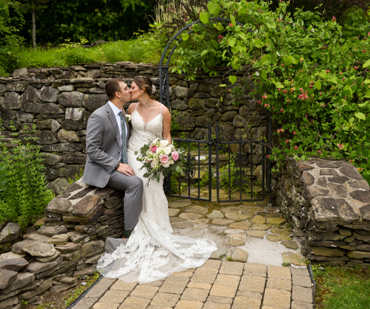 Couple kissing by lots of greenery - Granite Rose by Wedgewood Weddings-1