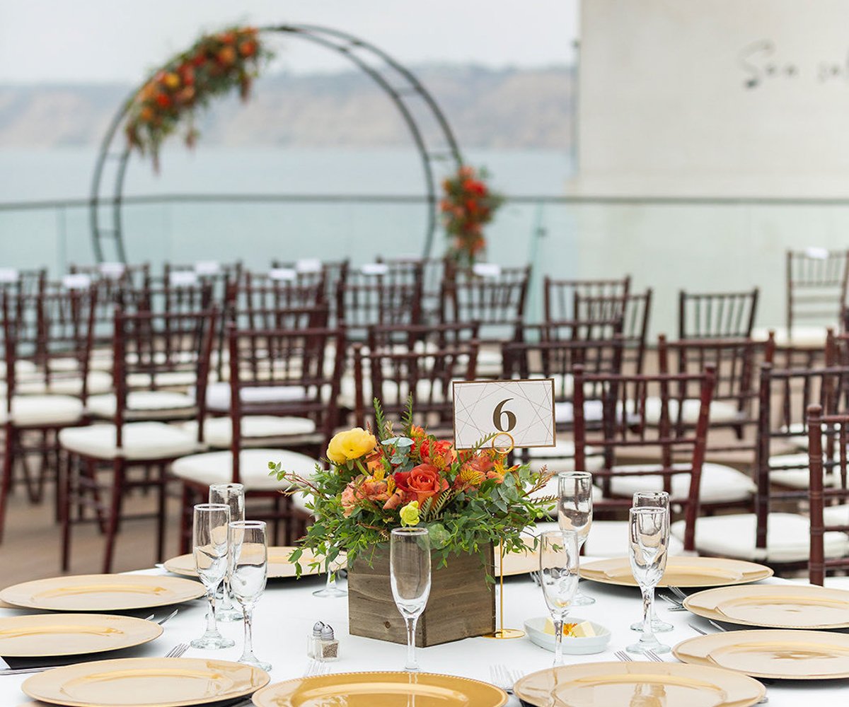 Rustic floral centerpiece with orange and yellow flowers - La Jolla Cove Rooftop by Wedgewood Weddings - 1