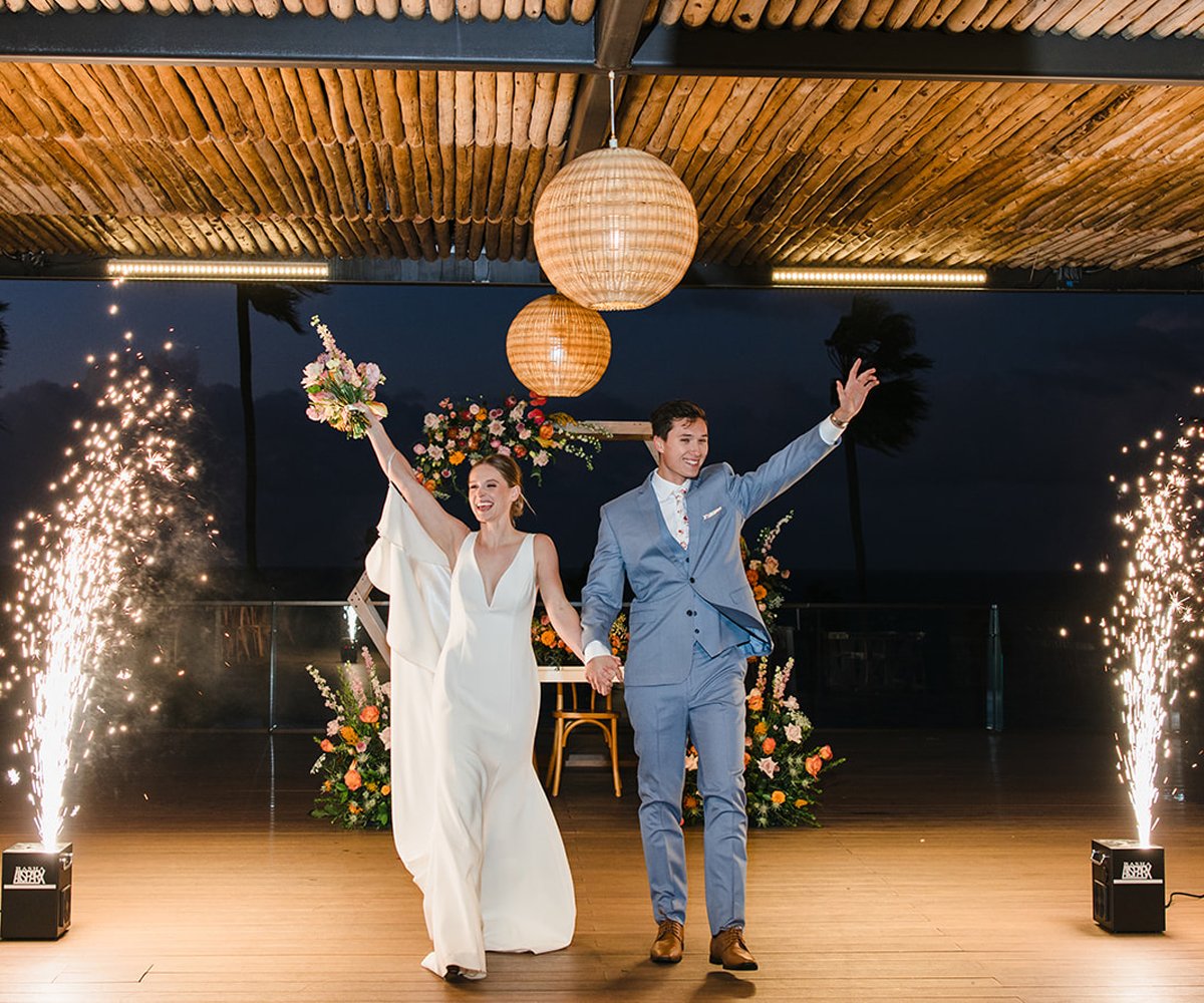 The-newlyweds-enter-with-a-grand-sparkler-moment-at-La-Jolla-Cove-Rooftop