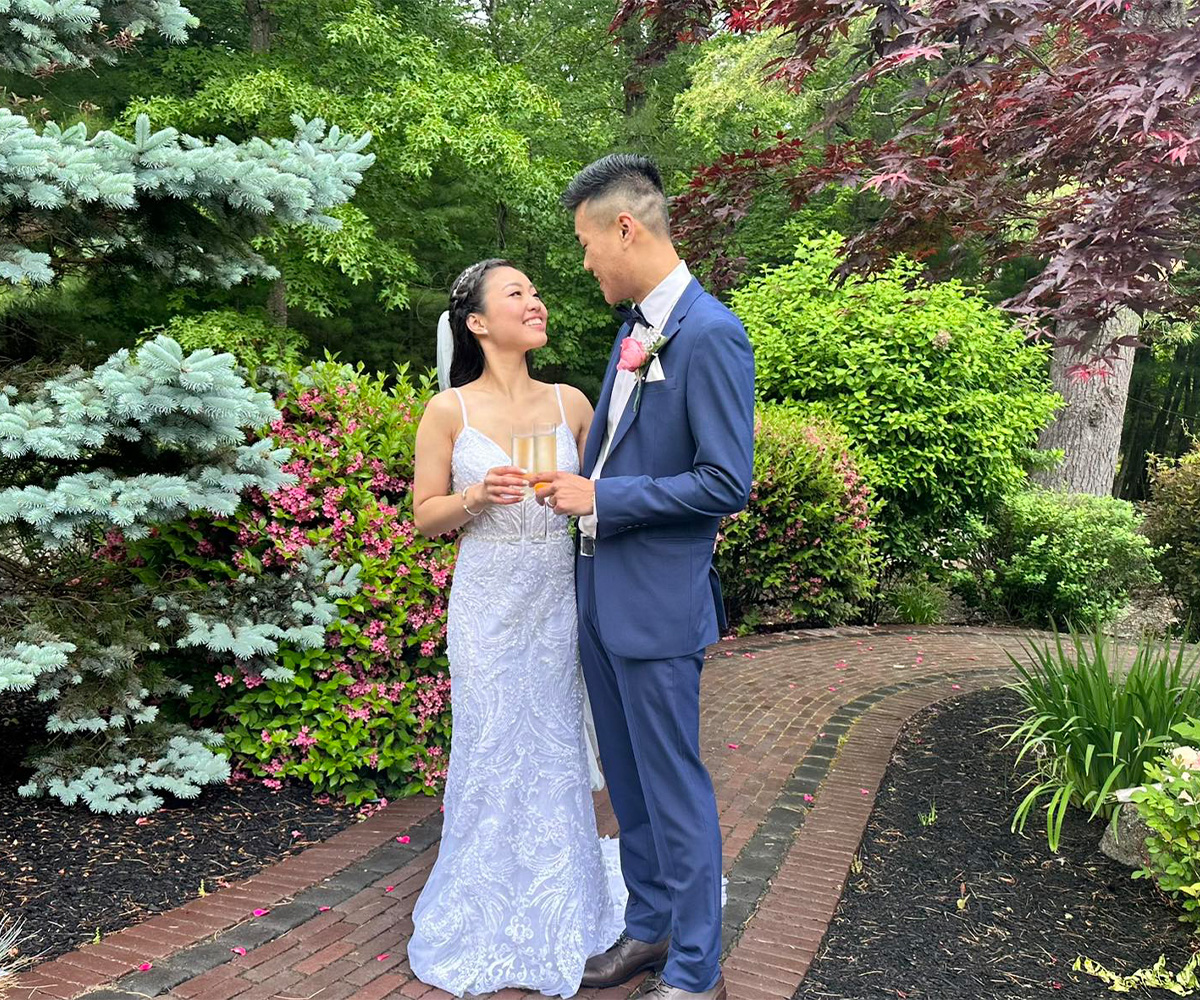 Couple enjoying champagne on paver walkway at Miraval Gardens by Wedgewood Weddings