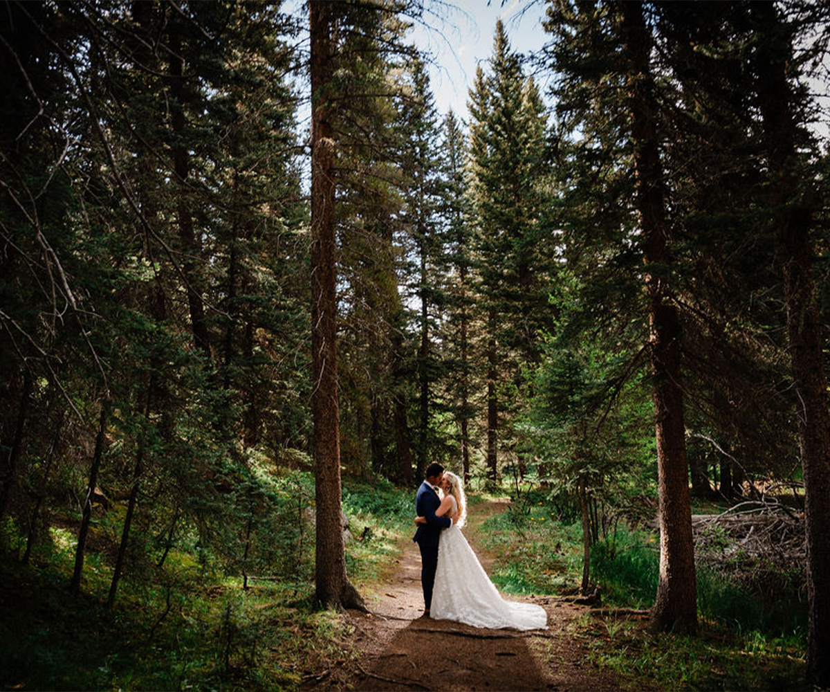 Couple kissing in forest at Mountain View Ranch by Wedgewood Weddings