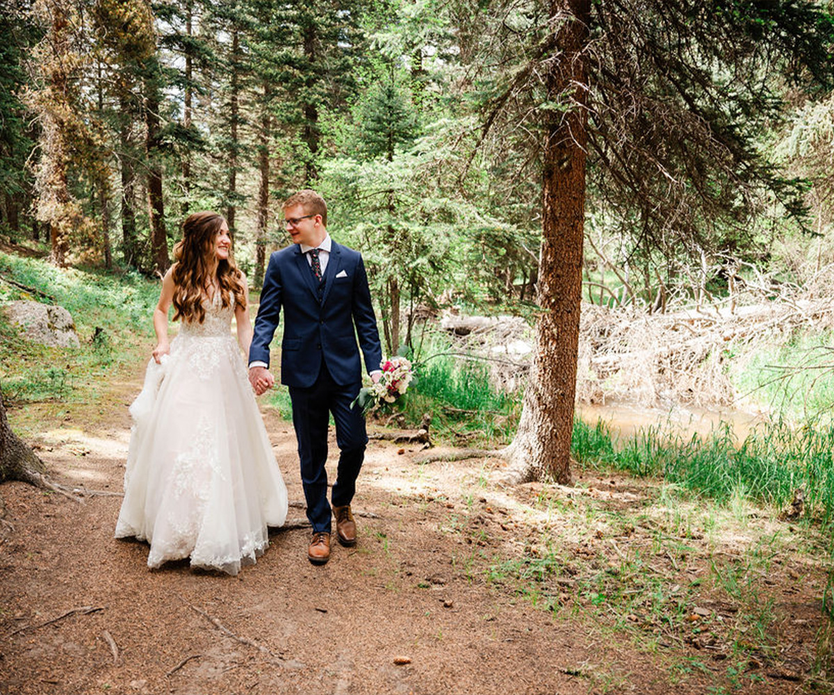 Couple walking through the forest at Mountain View Ranch by Wedgewood Weddings