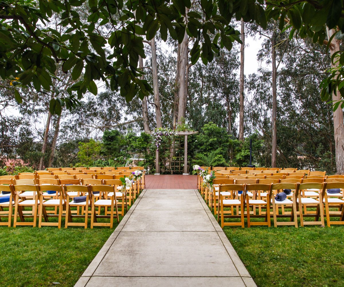 Alfresco ceremony site in San Franciscos Presidio Park surrounded by lush greenery - Presidio Chapel at the Golden Gate Club - Wedgewood Weddings