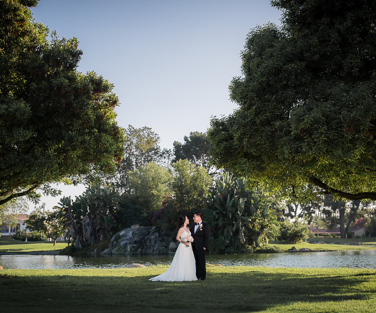 Couple photo op by pond with greenery at Rio Hondo by Wedgewood Weddings