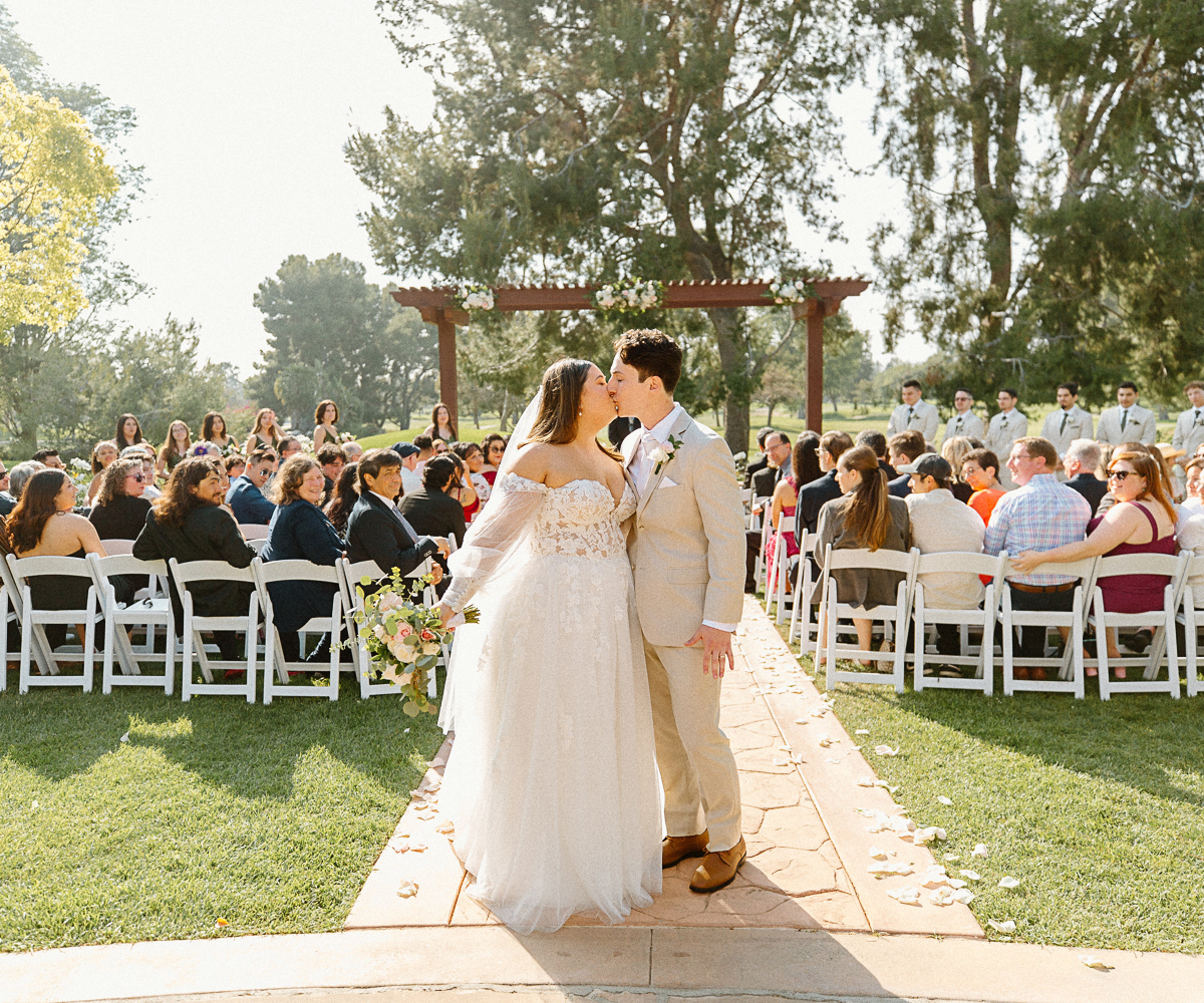 Couples kiss at ceremony - Rio Hondo by Wedgewood Weddings