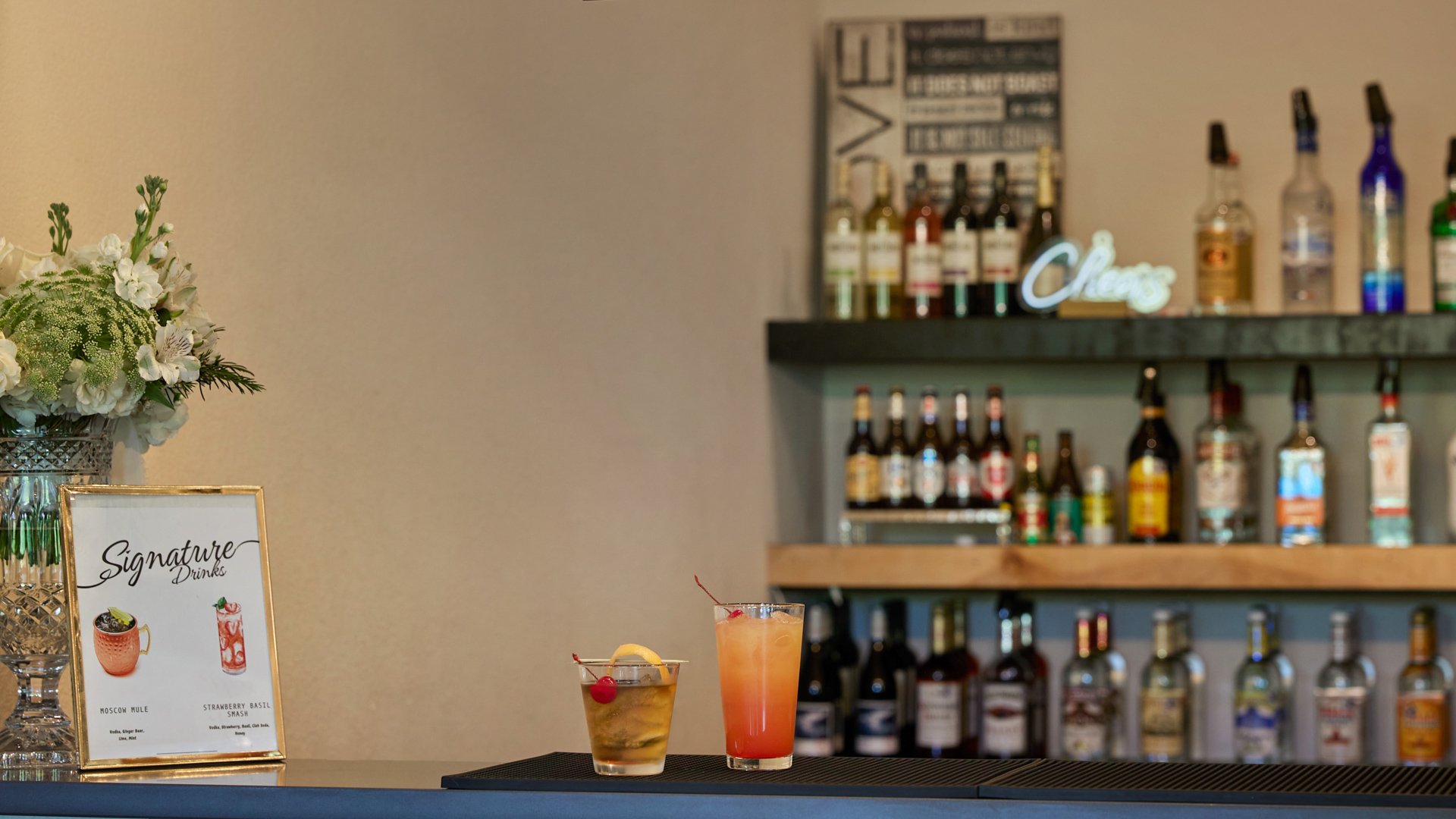 Scenic Springs wedding bar in Helotes, Texas, featuring signature drinks, floral arrangements, and a stocked back bar.