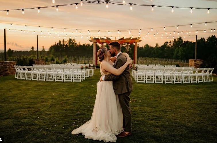 Bride and Groom during a beautiful sunset at the ceremony site at Spinning Leaf