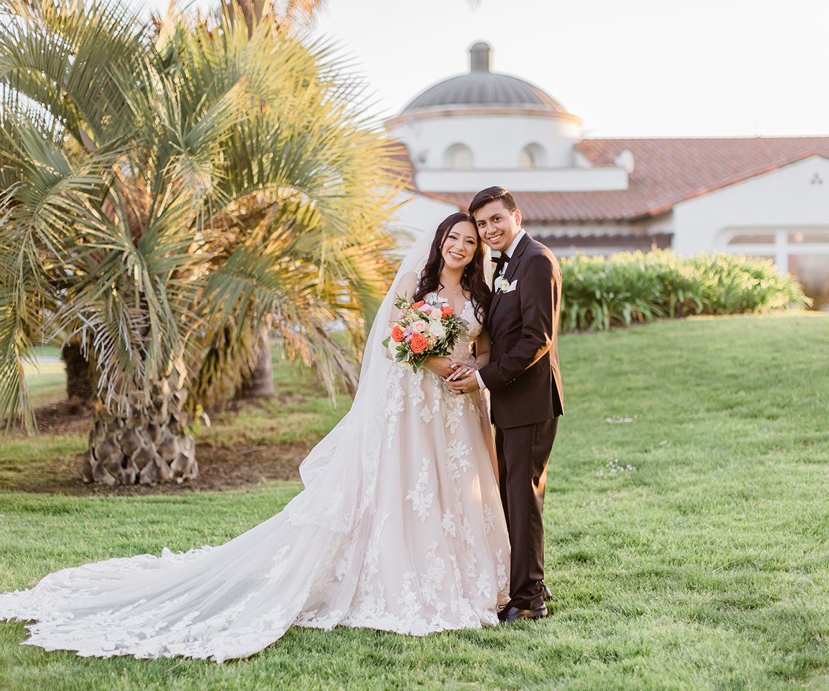 Bride and groom in front of palm trees at Sterling Hills