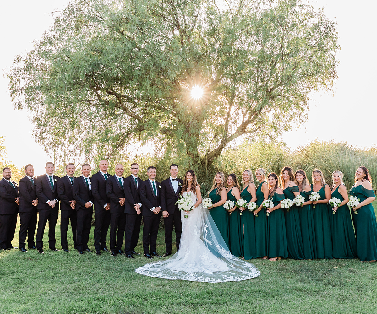 Wedding party outside large tree at Sterling Hills