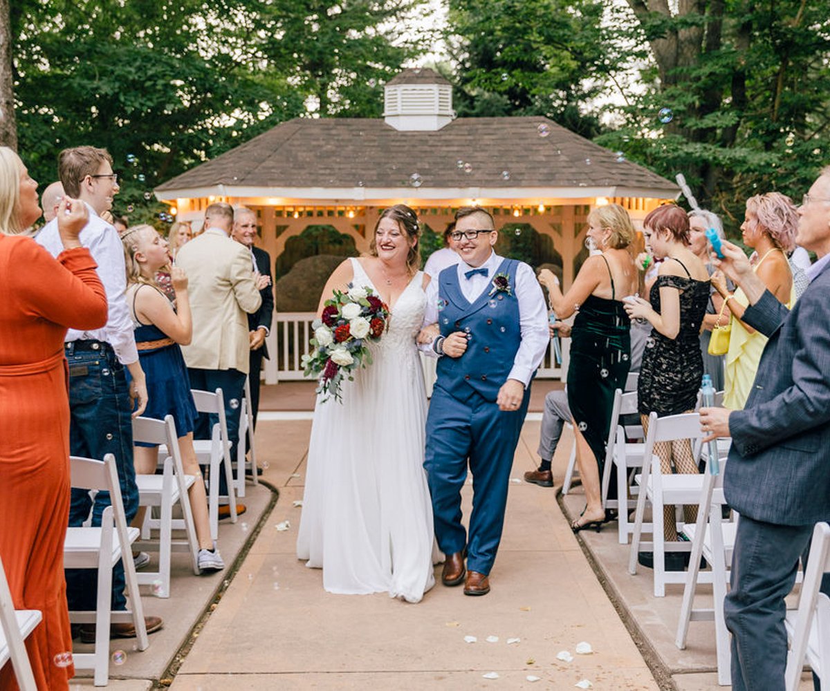 Bride and bride walking down the aisle after wedding ceremony - LGTBQ wedding -_