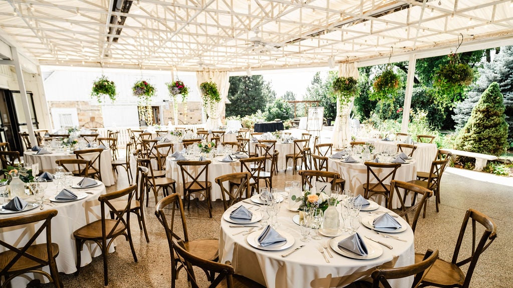 Covered reception in Northern Colorado with blue napkins and white linens.