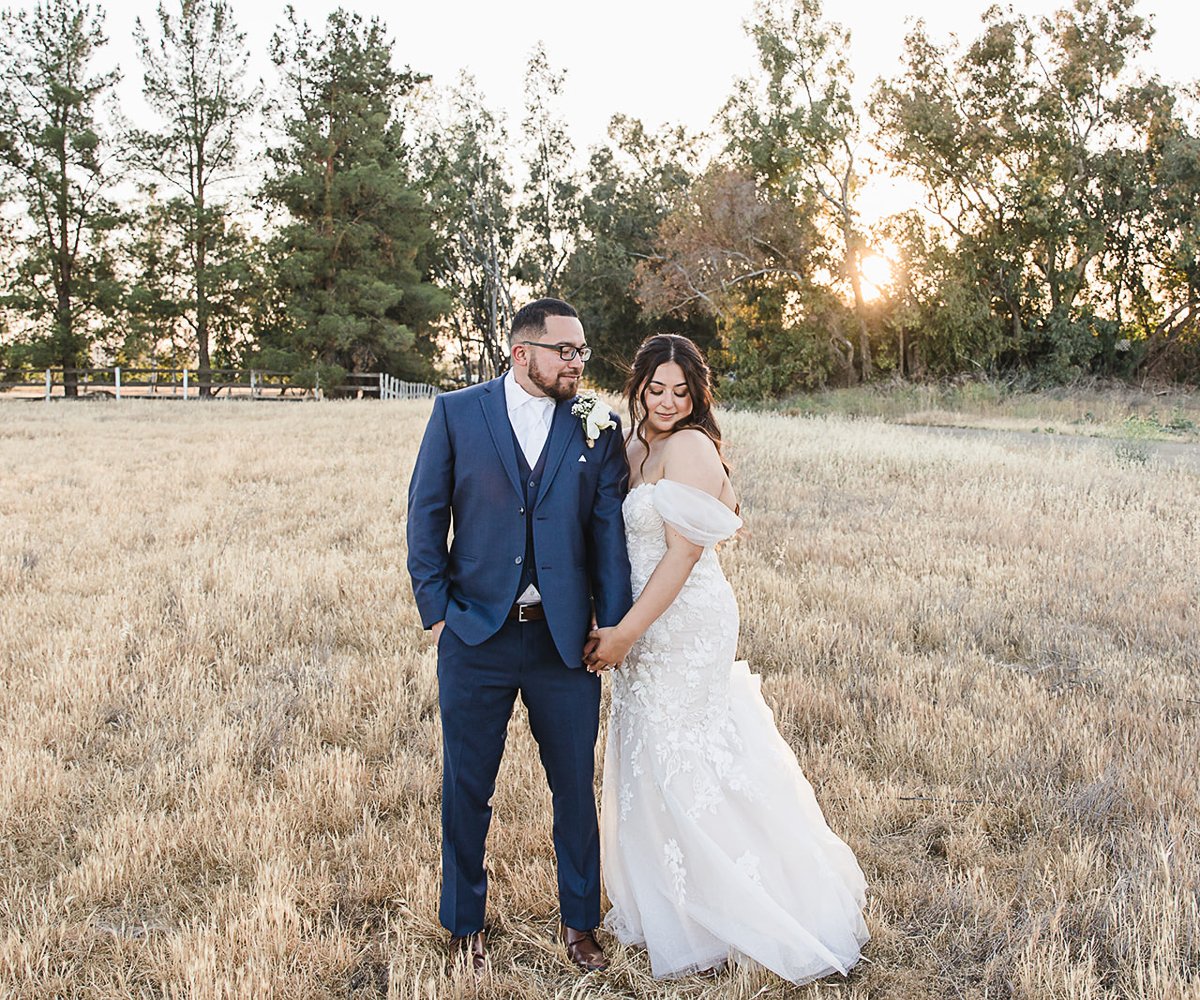 Couple in rustic field at The Orchard