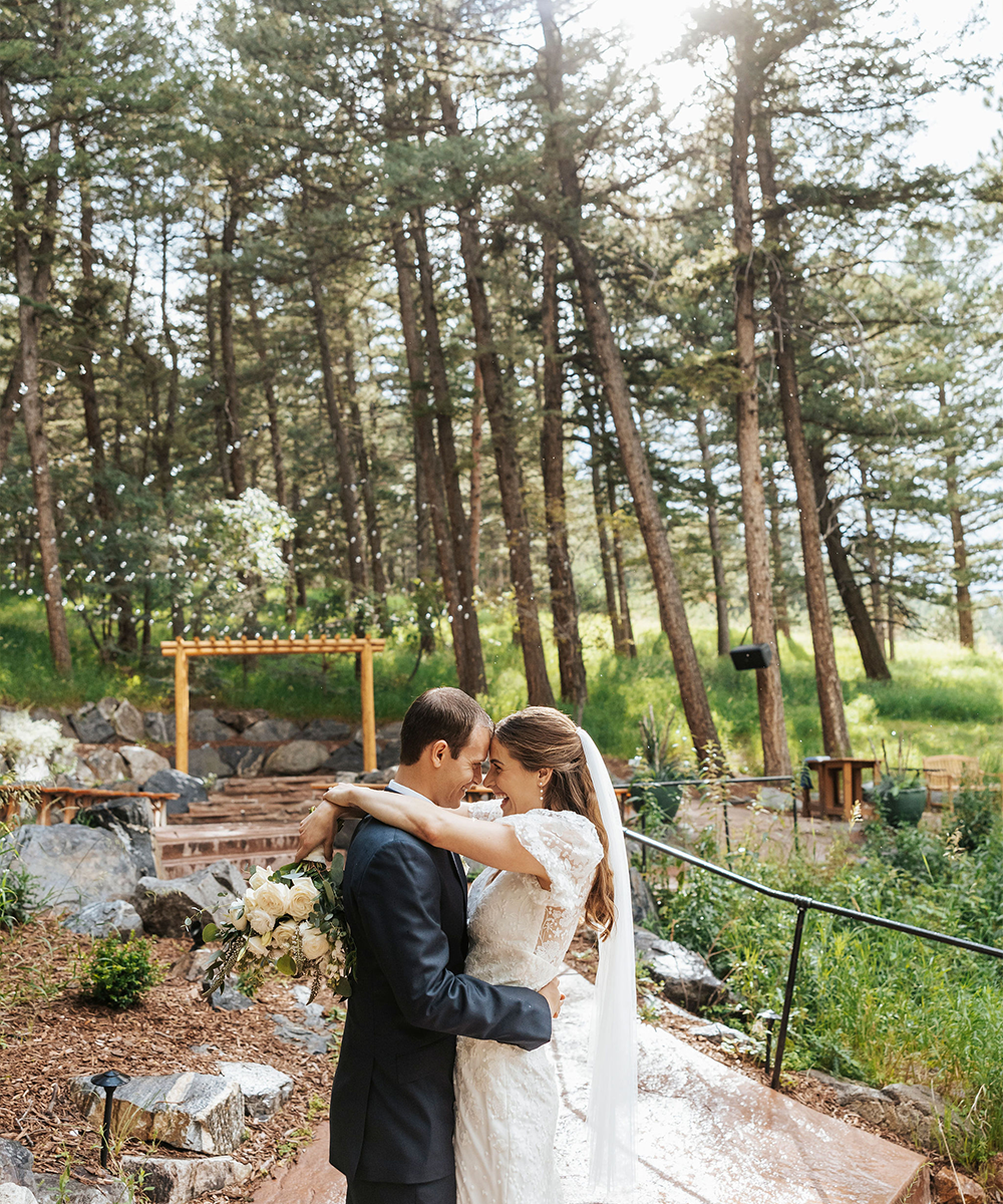 Couple with evergreen ceremony site-  The Pines by Wedgewood Weddings