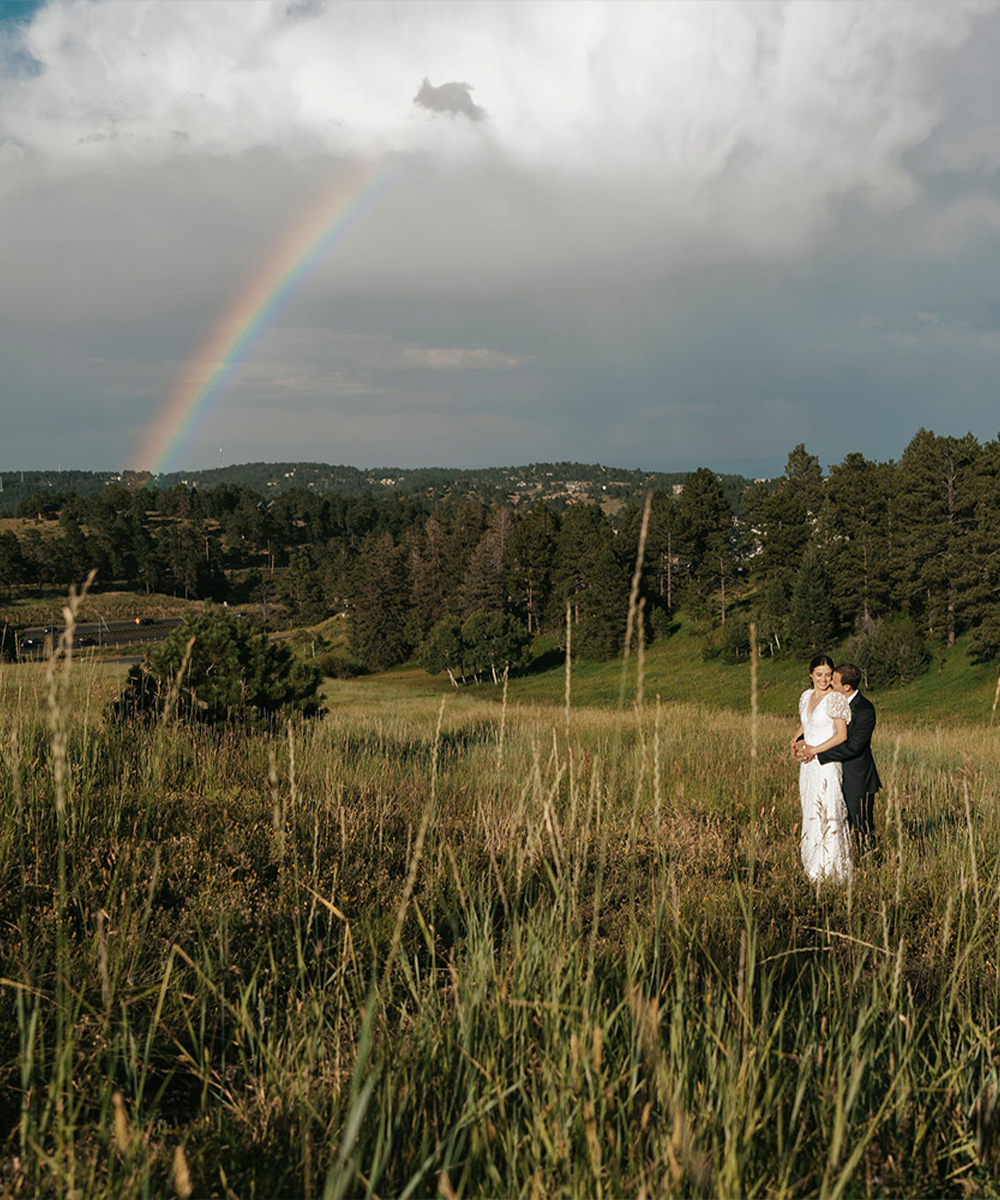 Couple with rainbow in meadow - The Pines by Wedgewood Weddings