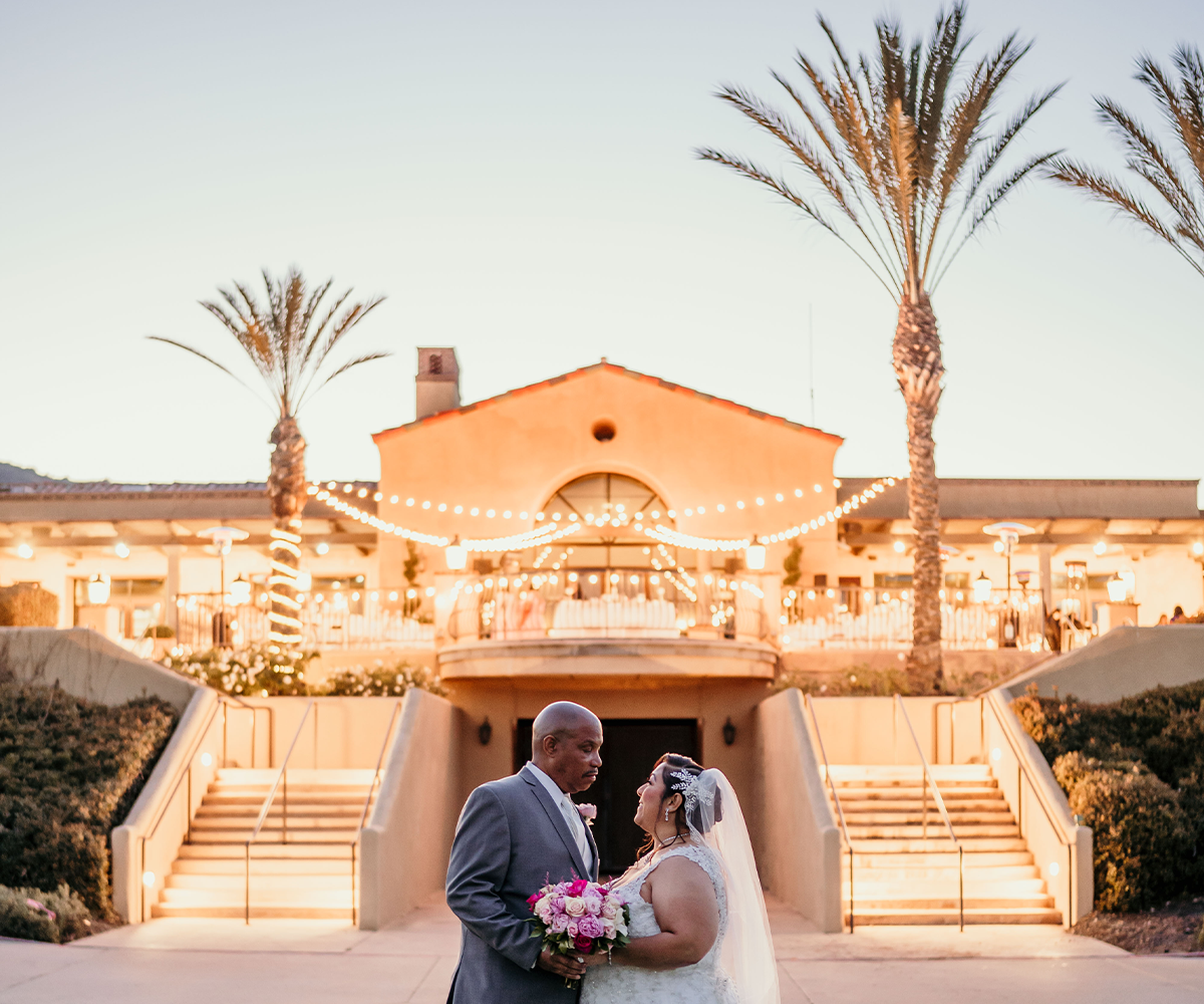 Couple with The Retreat by Wedgewood Weddings behind them