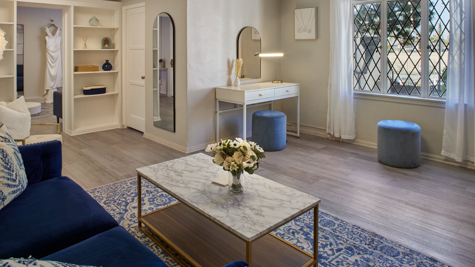 Wedding suite at The Sanctuary in Long Beach featuring vanity stations, natural light, and elegant blue and white décor.