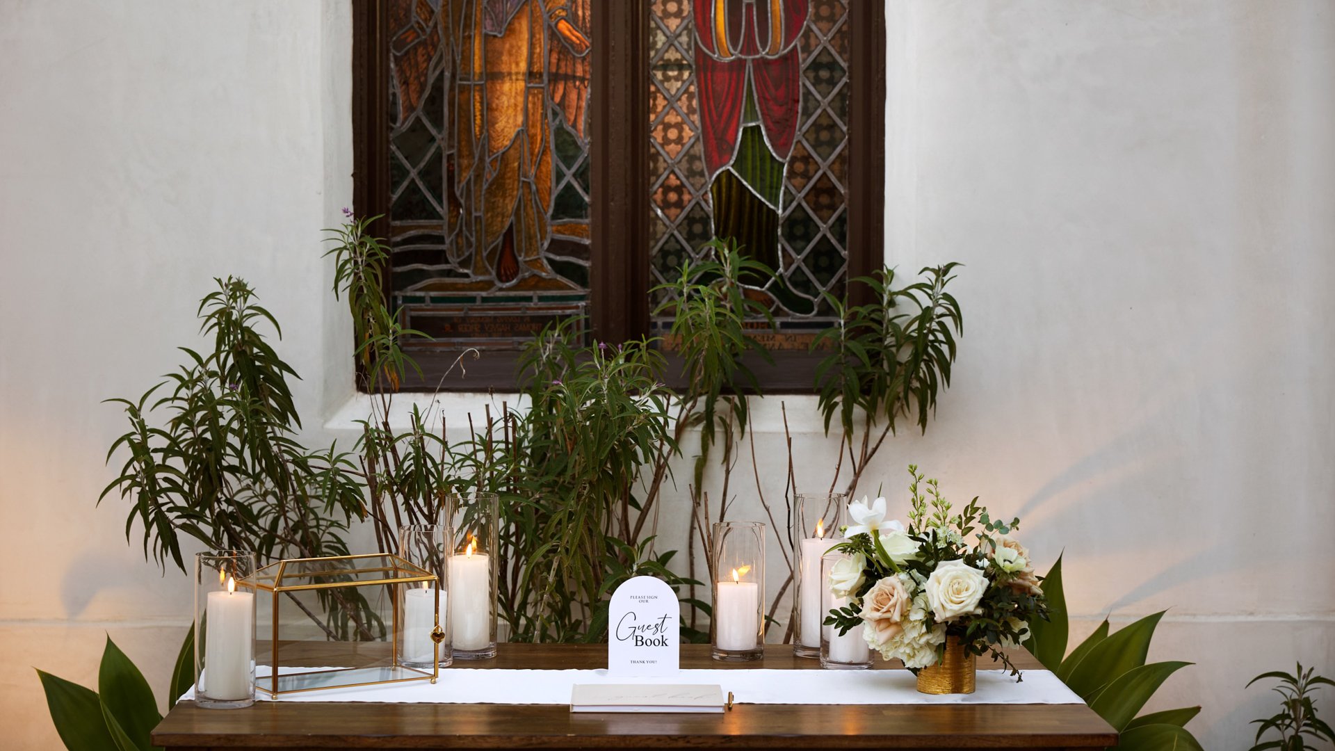 Overhead view of reception tables in The Sanctuary Grand Hall, Long Beach, with lush floral arrangements and gold accents.
