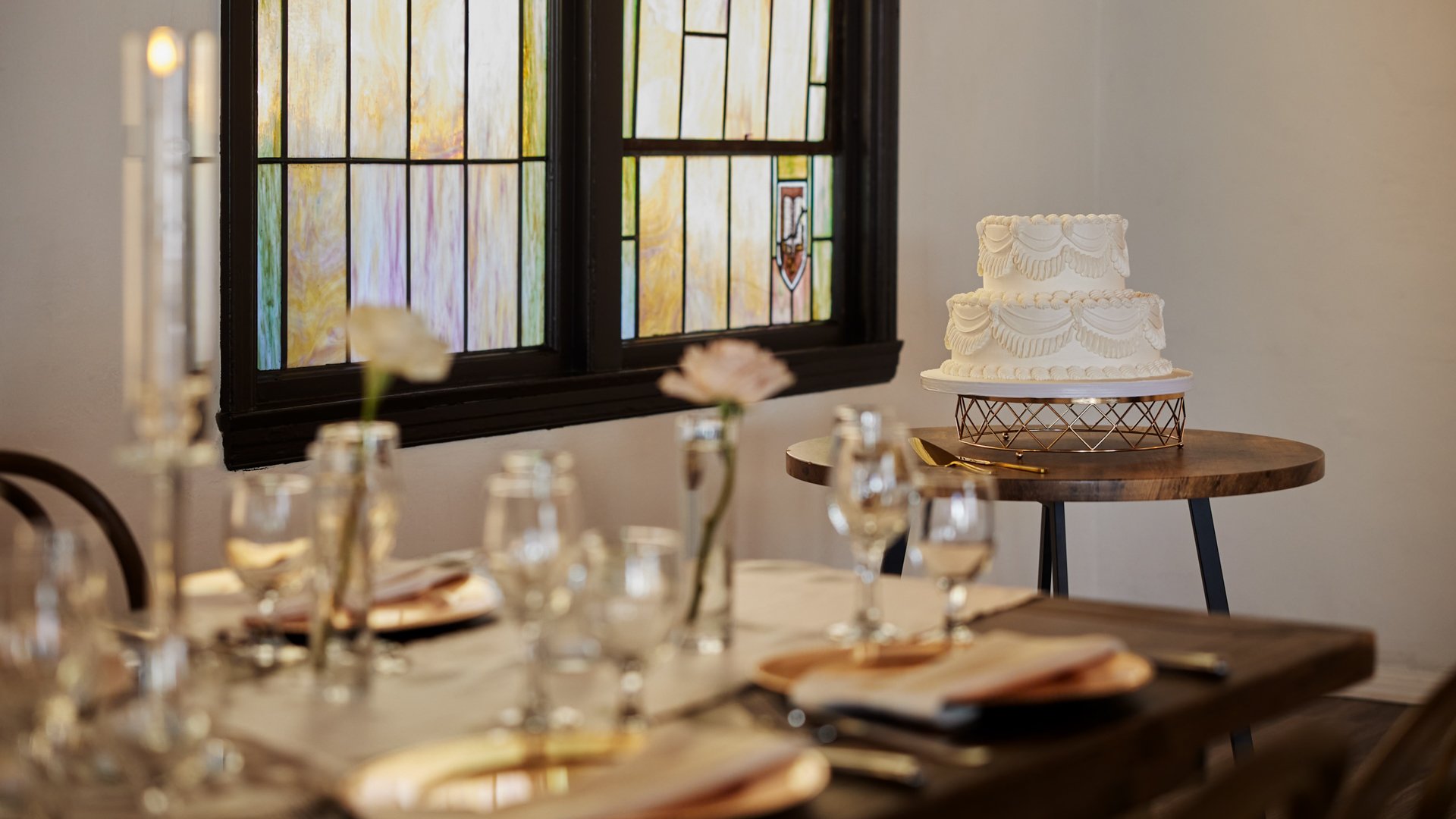 Sweetheart table in The Sanctuary Grand Hall, Long Beach, with white floral backdrop and gold accents.