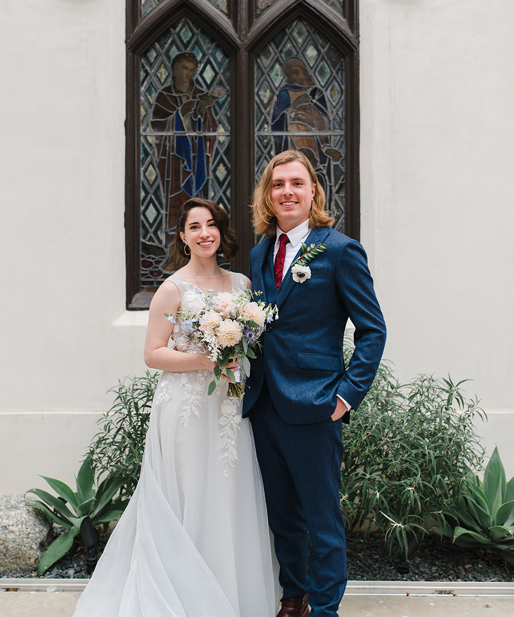 Couple by stained glass window - The Sanctuary by Wedgewood Weddings