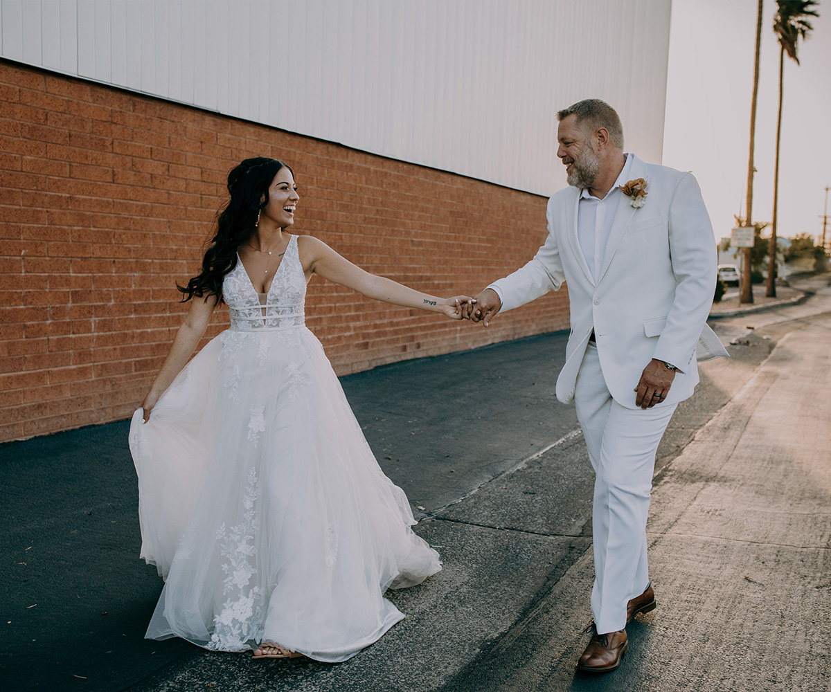 Couple walking down brick alleyway - Tre Bella by Wedgewood Weddings