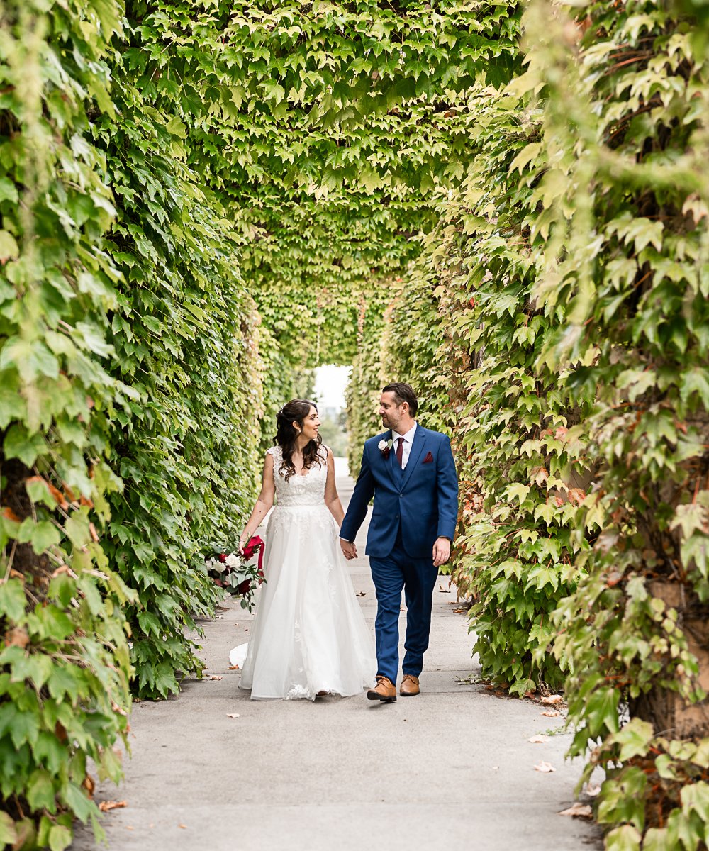 Couple in greenery walkway at University Club