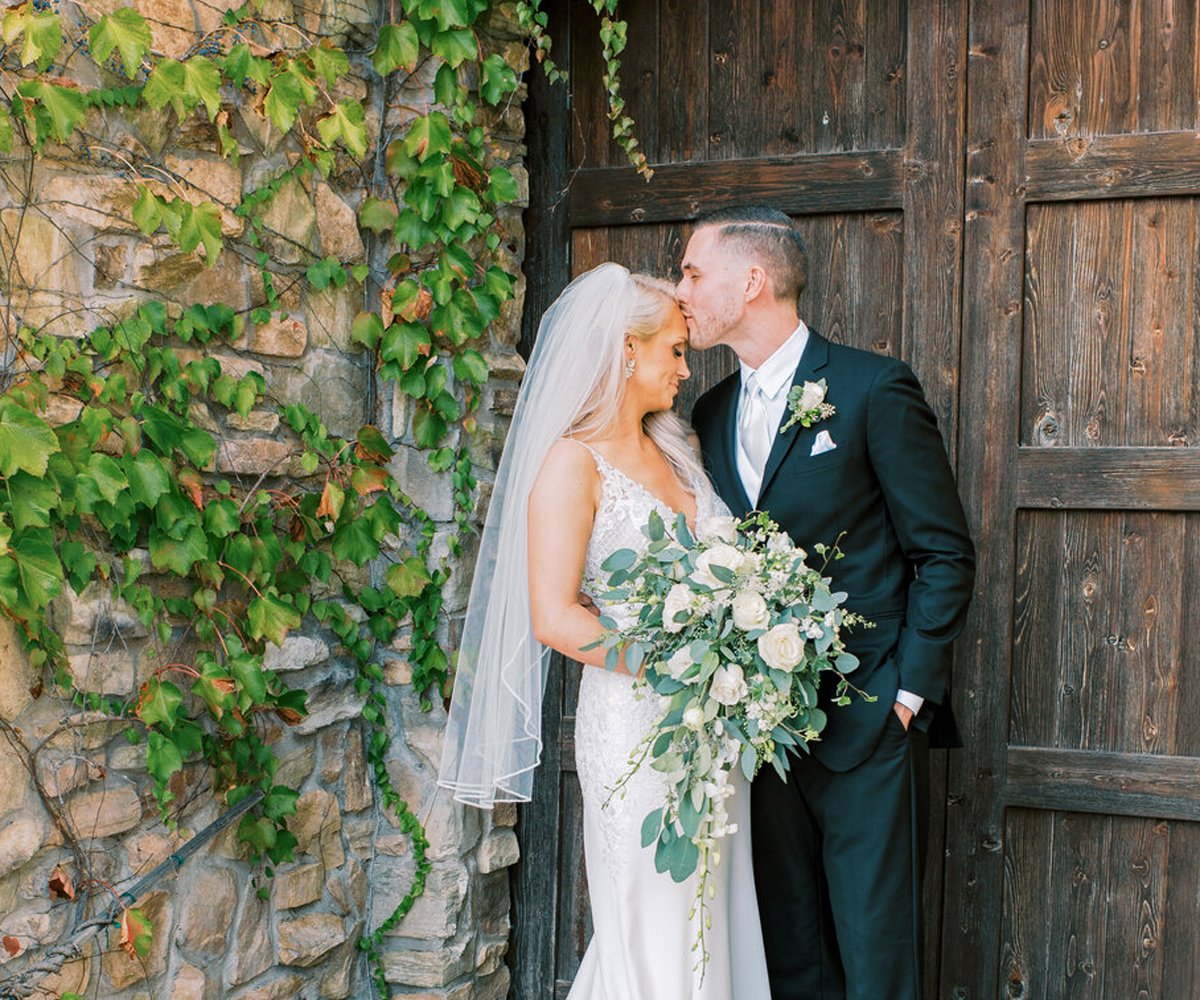 Bride and groom in front of wooden door - Winchester Estate by Wedgewood Weddings