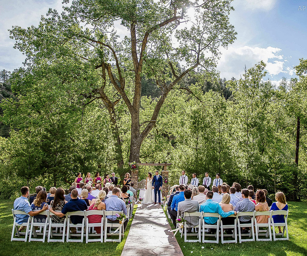 Sunny Top Lawn Ceremony Area at Boulder Creek with Vibrant Greenery and Floral Accents