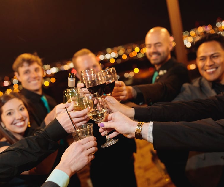 guests cheers'ing at a wedding