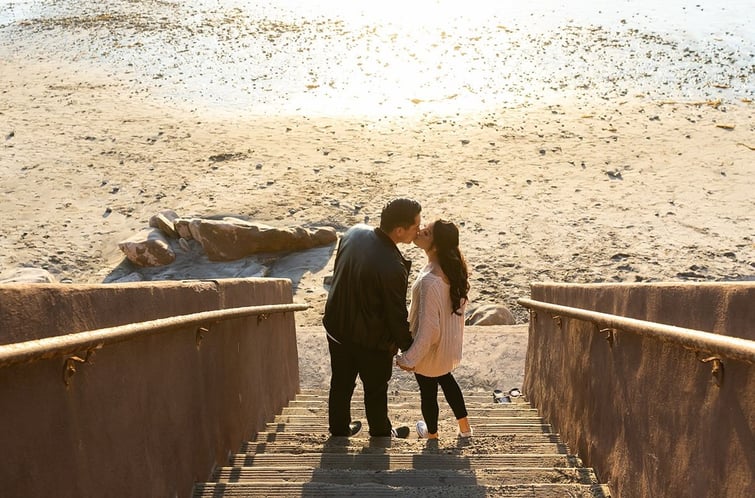 a couple kissing at the beach